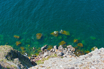 Top-down view of the shore and water of Lake Baikal.