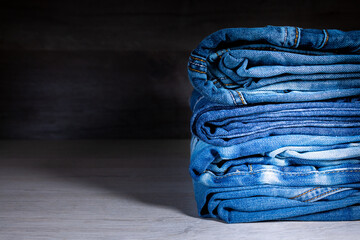 Neatly folded denim clothing. Background on the theme of jeans.