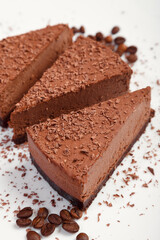 A piece of chocolate cake on a white plate on a wooden background