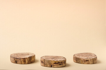 three round cut wooden platform on beige background, geometric podium, pedestal, mock up, eco scene for presentation of beauty products
