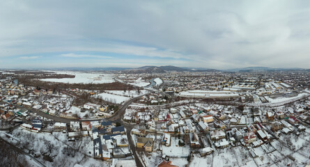 Aerial view of Mukachevo Zakarpattia, Ukraine. Roofs covered with snow, winter view of the city. Tourism and travel. widescreen panorama of large resolution