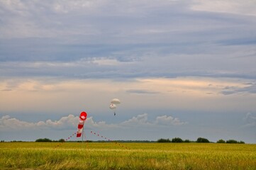 The parachutist descends on the main and reserve parachute