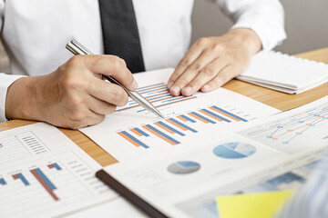 Finance staff is preparing company financial documents, data sheets in the form of charts as the company's financial, sales and expenditures to be brought into the meeting. Financial concept.