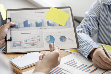 Finance workers are working together to prepare company financial documents for the meeting with management, together they are checking the accuracy of the information. Financial concept.