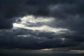 Background of dark clouds before a thunder-storm. Cumulus clouds moving in the sky. Evening sky cloudscape