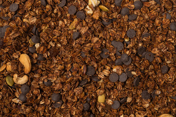 Chocolate granola cereal with nuts background.
