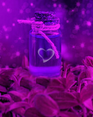 Magic potion in a glass bottle with a cork on a magic background with stars, sparks and green...