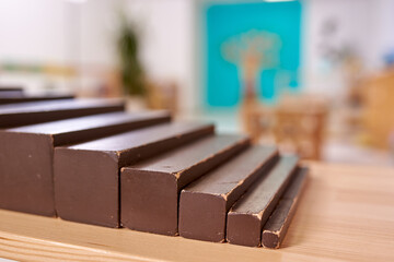 Light class in Montessori kindergarten. The brown stairs is in the foreground. nobody