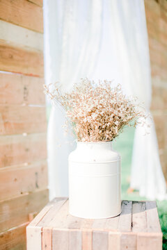 Close-up Of White Flower Vase On Table At Wooden Table