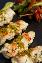 Fried Chicken with Korean Sauce on black dish. Shallow dof