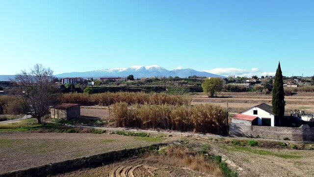 Drone aerial view of Moncayo snow mountain in Spain flying back with storks