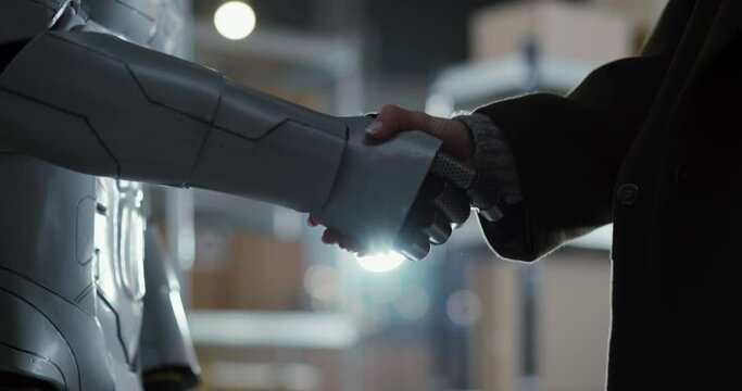 Handshake of Female and Robot Making Agreement. Close-up Hands of Woman Boss Hiring Cyborg for Work Signing Contract Interacting for Cooperation.