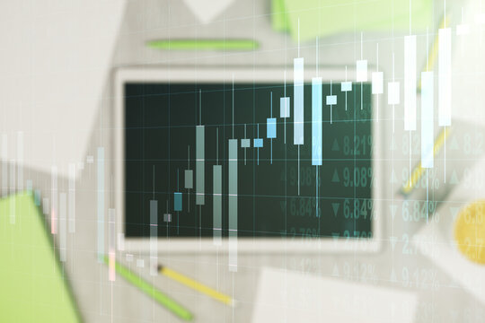 Abstract creative financial graph and modern digital tablet on background, top view, forex and investment concept. Multiexposure