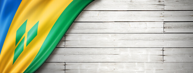 Saint Vincent and the Grenadines flag on old white wall banner