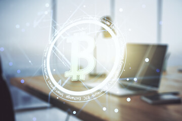Double exposure of creative Bitcoin symbol hologram with computer on background. Mining and blockchain concept