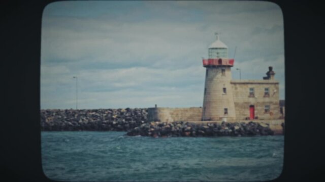 Picturesque landmark lighthouse in Howth, Ireland. Vintage Film look. 