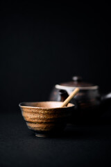 Traditional, handcrafted ceramic on dark background. Soft focus. Close up.	