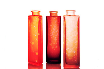 Three original, colored, frosted glass bottles.