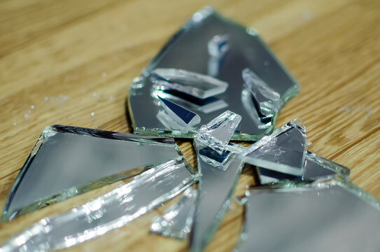 Broken Mirror Fragments, Bad Omen, Superstition. Close-up, Selective Focus.