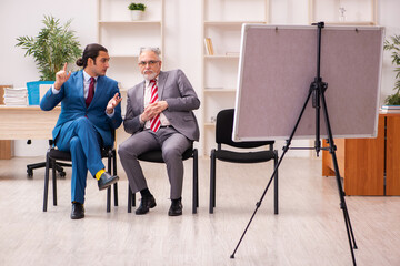 Two male employees in business meeting concept