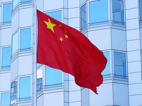 Low Angle View Of Chinese Flag Against Building