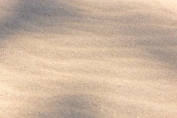 Fototapeta na wymiar Sand background texture. Wave pattern Sandy beach backdrop