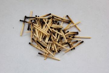 A pile of burnt matches on a white background.