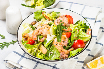 Seafood salad with green leaves and vegetables.