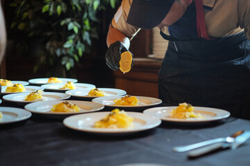 Chef squeezing lemon on food