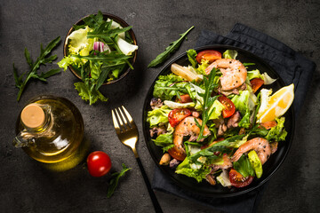 Seafood salad at black table.