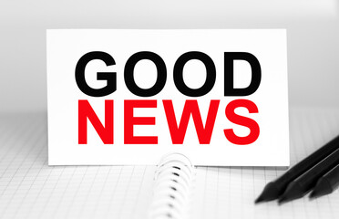 Text GOOD NEWS on paper card, Pencils on table - business, banking, finance and investment concept.