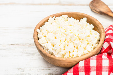 Curd or cottage cheese at wooden table.