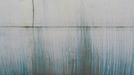 Old silver metal surface of the aircraft fuselage with rivets. High quality photo