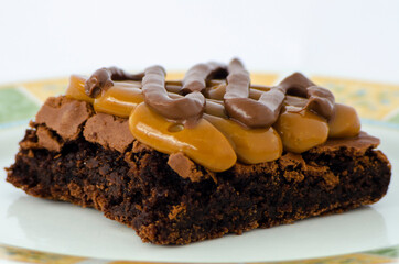 Chocolate brownie topped with caramel and hazelnut spread close up