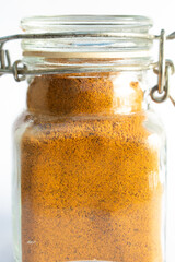 turmeric in a small spice jar isolated