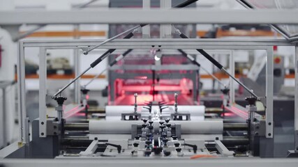 Modern automatic machine line of cardboard box. Conveyor line for the production Manufacture of cardboard boxes from paper. gluing of cardboard.