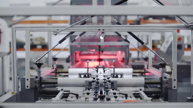 Modern automatic machine line of cardboard box. Conveyor line for the production Manufacture of cardboard boxes from paper. gluing of cardboard.
