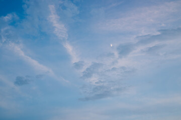 Bright blue sky with white fluffy clouds and bright sunlight.