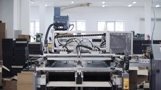 Modern automatic machine line of cardboard box. Conveyor line for the production Manufacture of cardboard boxes from paper. gluing of cardboard.