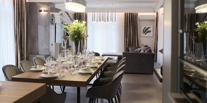 Elegant interior of modern home with festive served table and sofa inside msspe.