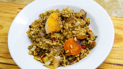 flat lay of dish of stew with rice, vegetables and meat