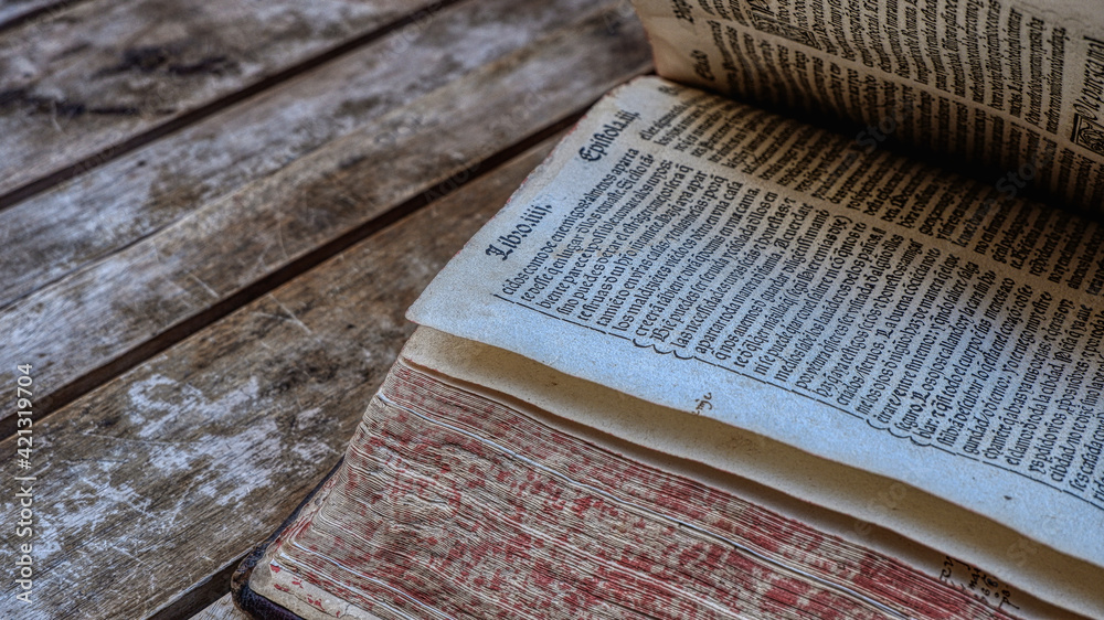 Fototapete an old book on a wooden table. a 15th-century book written in spanish using the gothic script. selec
