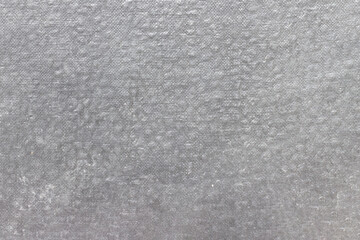 Fototapeta premium The texture is old gray paper, covered with stains. Uneven light fibrous structure.