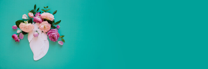 Human heart organ concept with flowers as a circulatory anatomy made of paper as a medical health care symbol of an inner cardiovascular body part.