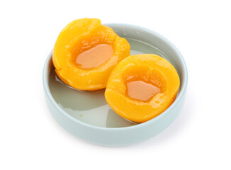 canning peaches isolated on blue plate.