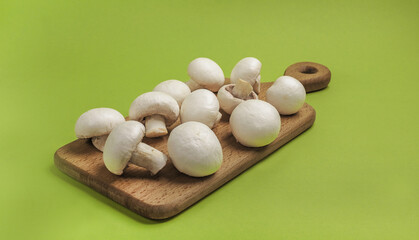 Mushrooms. Peeled fresh champignons on a cutting board.