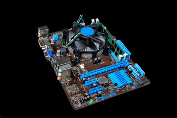 Motherboard, CPU with cooler and RAM on a black background.