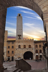 Picturesque View of famous Piazza del Duomo in San Gimignano at sunset, Tuscany, Italy