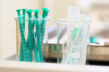 Two measuring cups filled with injections in laboratory
