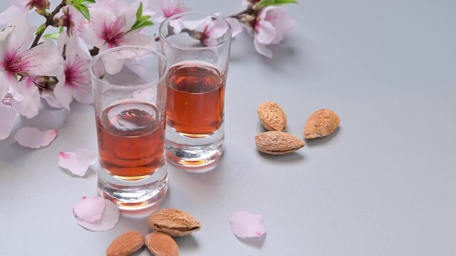 almond liquor. The traditional strong drink in italy to complete the dinner is a liqueur made from nuts and berries. Ratafia, alcohol in shot. Slow motion 